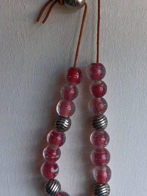 Worry beads used with 15 transparent red glass and 5 metal beads