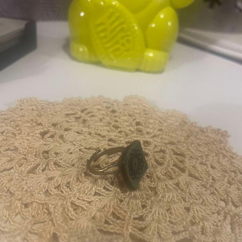 Metal ring used with adjustable green ceramic flower