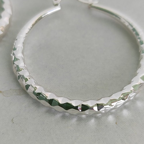 Silver-tone hoop earrings like new with diamond-cut texture