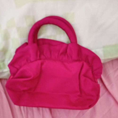 Pink handbag with zipper and handles