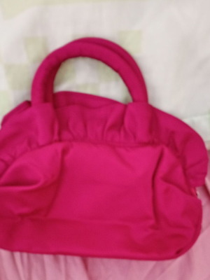 Pink handbag with zipper and handles