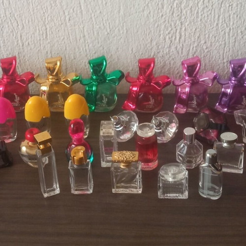 Collection of 29 empty perfume miniatures like new