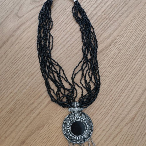 Long necklace with round pendant and bells, like new