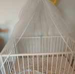 Wooden baby cot used with mattress and mosquito net