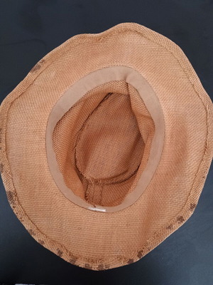 Straw-like hat used, tan with marks