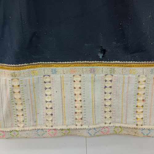 Traditional collectible wool dress used with wear due to age