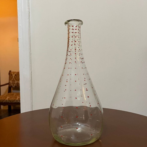 Vintage glass pitcher used with red decorative details