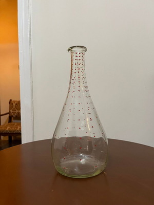 Vintage glass pitcher used with red decorative details