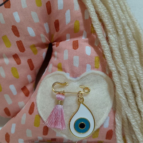 Newborn amulet unicorn salmon with safety pin, evil eye and tassel