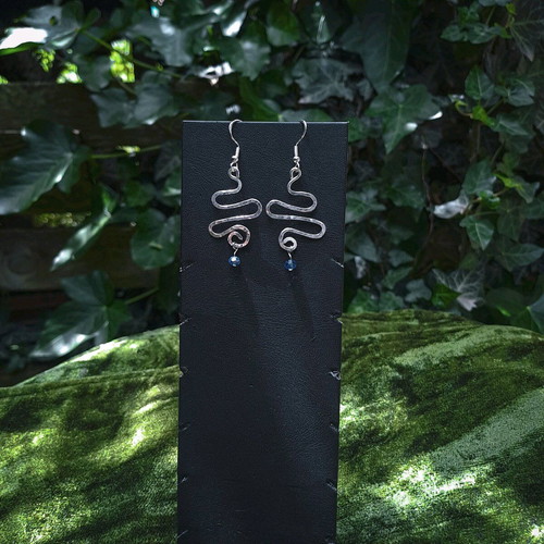 Swirly silver earrings with light blue crystal new