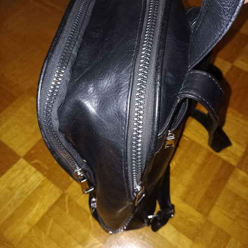 Backpack black leather type used with multiple pockets