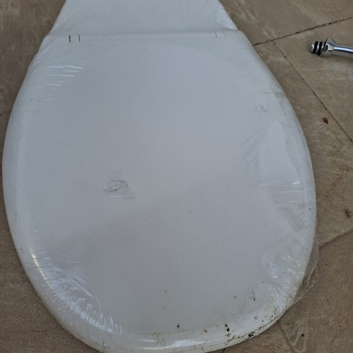 Toilet seat new, wrapped in cellophane