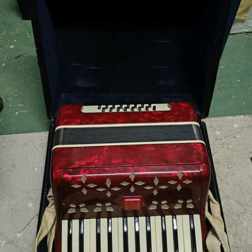 Accordion piano type with red pearlescent lid in case