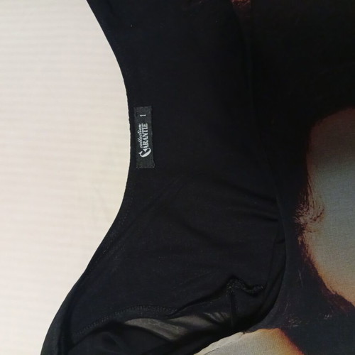 Black asymmetrical blouse with transparent chiffon and print Garantie used