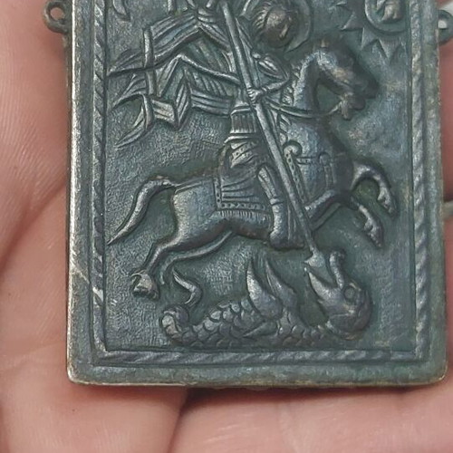 Old religious amulet with wear, needs repair