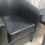 Black leatherette 2-seater sofa, 2 armchairs and 2 IKEA tables