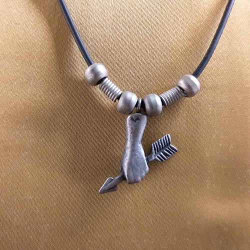 Short necklace used with hand holding arrow pendant in white metal