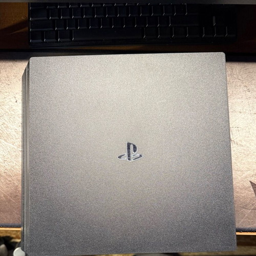 PlayStation 4 Pro used with controller and two games