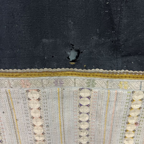 Traditional collectible wool dress used with wear due to age