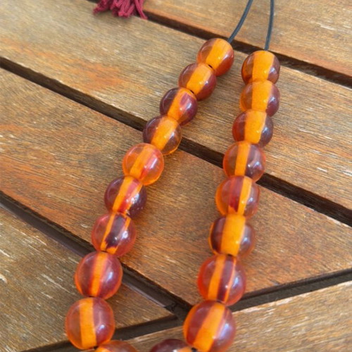 Worry beads used, large with brown orange beads and burgundy tassel