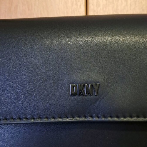 Dkny black leather crossbody bag like new with knot design strap