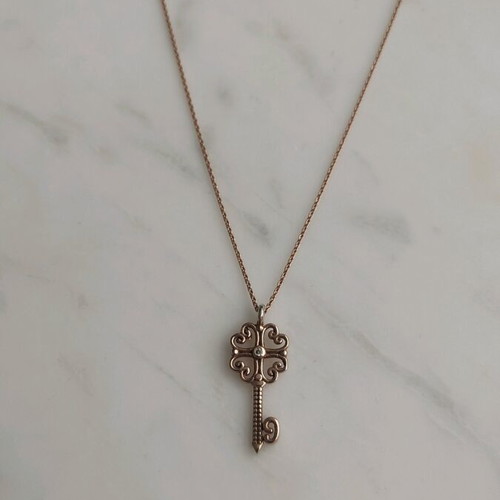 Silver gold-plated key-shaped pendant like new