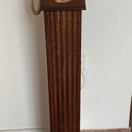 Antique hotel telephone used, wooden column with brass supports