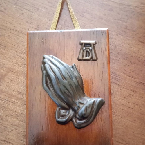 Vintage metal praying hands used mounted on wood