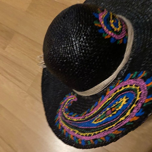 Painted hat on black background new for distinctive ladies