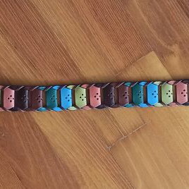 Colorful woven belt in warm shades made of faux leather, like new