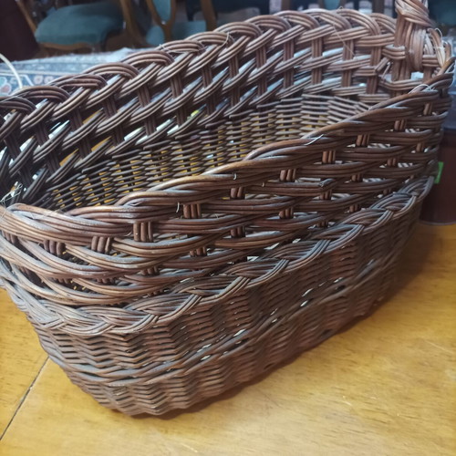 Handmade dark brown wicker basket with high arched handle