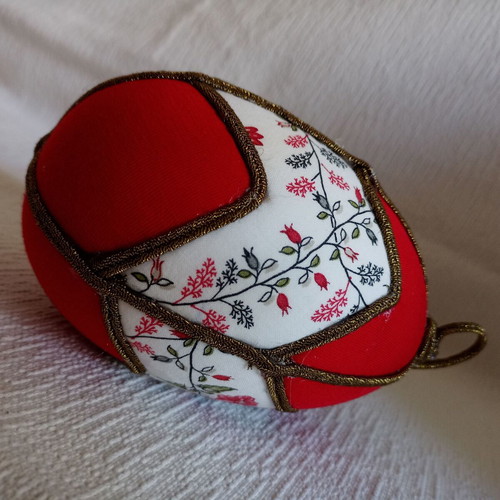 Decorative red egg used with geometric design and bronze border