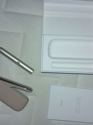 IQOS devices, beige and black, new, sold separately