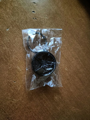 Keychain new, black, wheel rim shaped