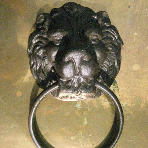 Cast iron door knocker used with lion head