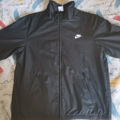Nike unisex jacket used with colorful letters and small tear