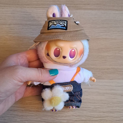 Labubu doll with pastel pink, purple, and blue clothes like new