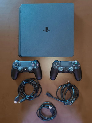 Sony PlayStation 4 Slim 1TB console used with 2 DualShock controllers and 14 games