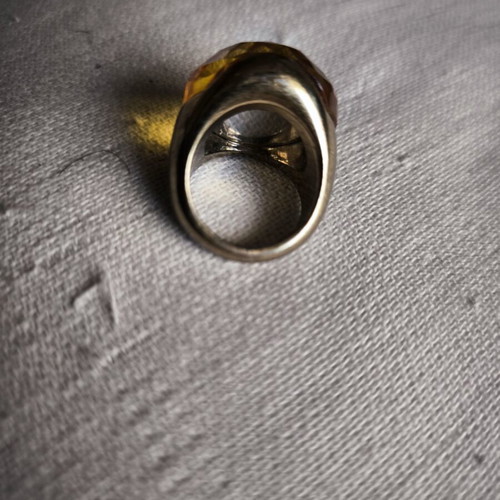 Statement ring with thick honey-colored glass on gold metal, used