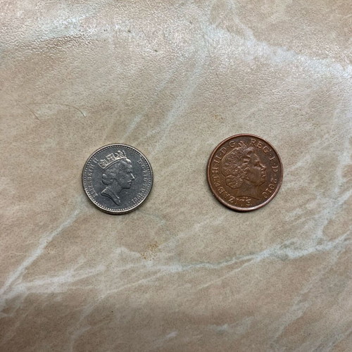 Coins one penny 2010 and five pence 1991 used