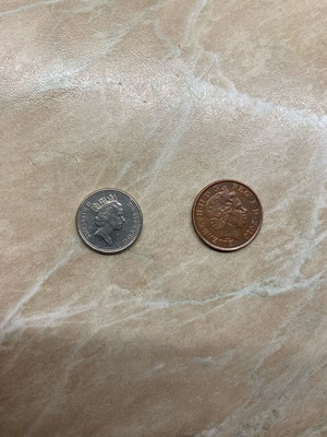 Coins one penny 2010 and five pence 1991 used