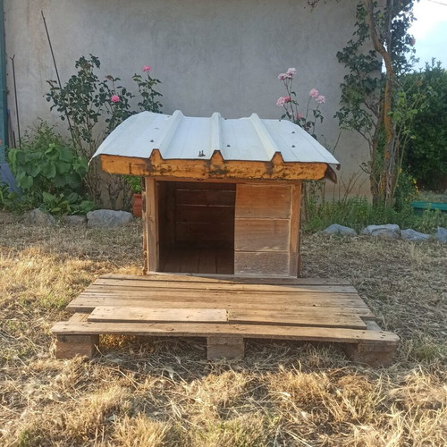 Custom wooden dog house with panel roof and removable veranda