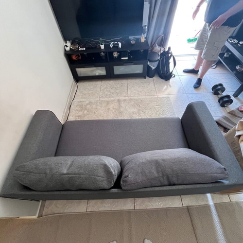 Two-seater grey sofa bed