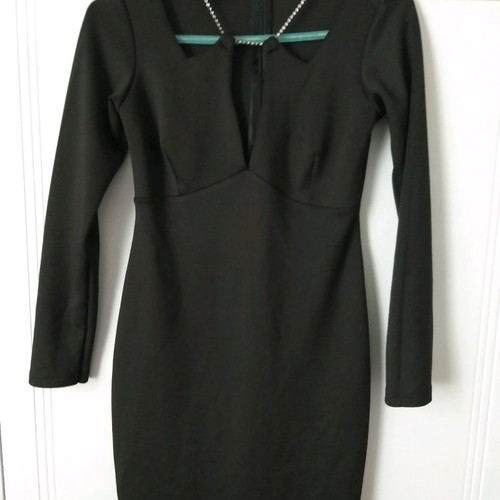 Black dress size M with open neckline, unused