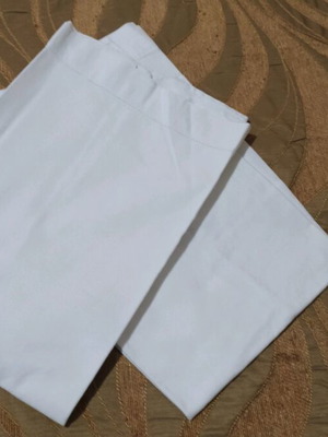 Set of 2 white pillowcases used for sleeping