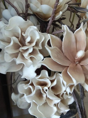 Decorative floral arrangement with large earth-tone flowers