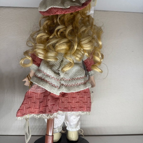 Porcelain doll new with tag and base