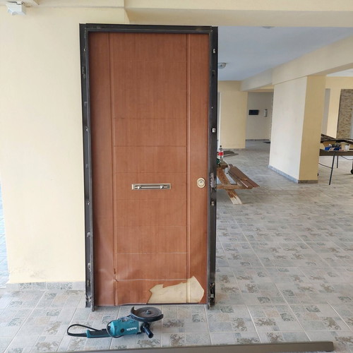 Security door used, fully functional with exterior covering damage