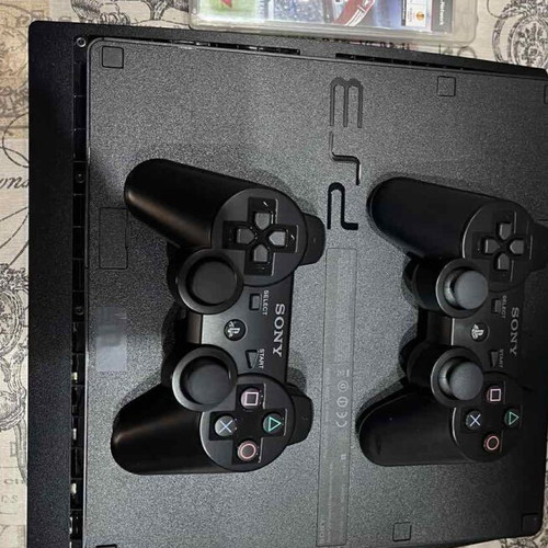 PlayStation 3 (PS3) like new with 2 games and 2 wireless controllers