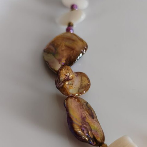 Necklace with mother of pearl and gold steel sun pendant